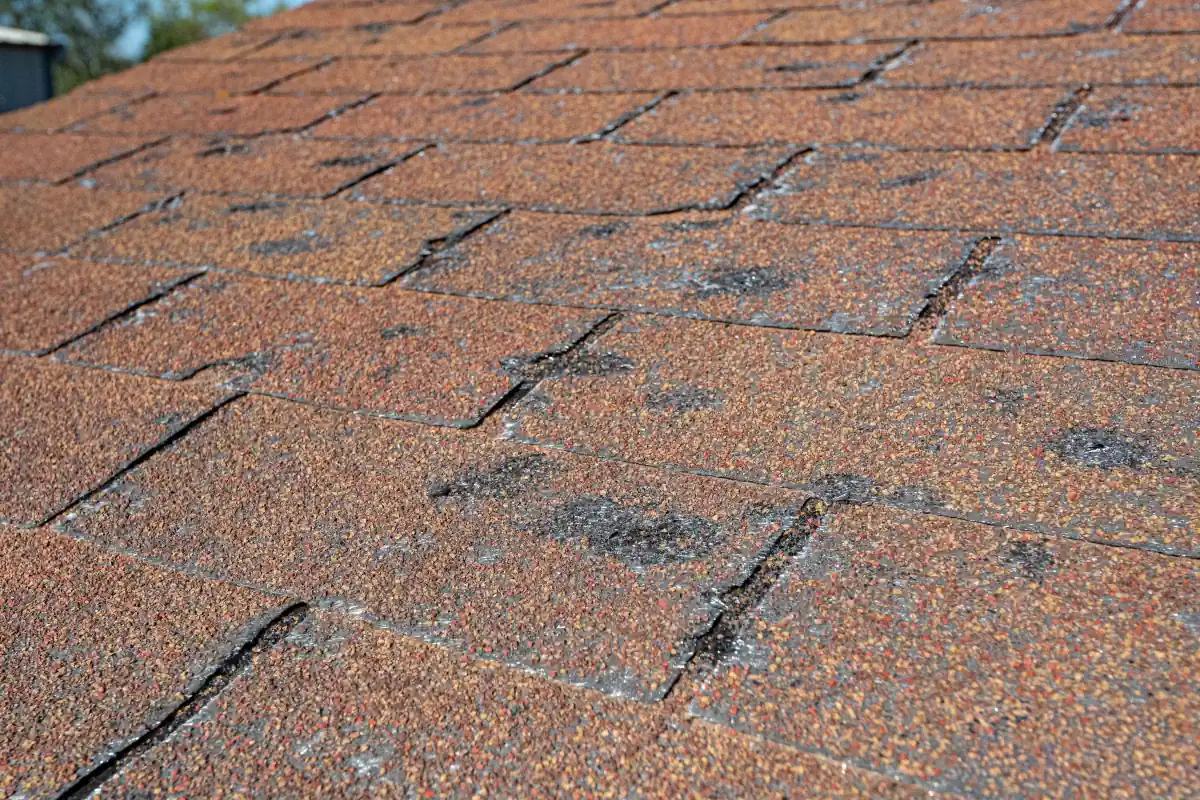 Before: worn, hail-damaged 3-tab asphalt shingles