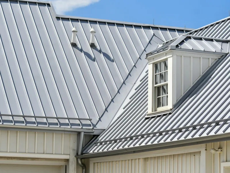 Grey standing-seam metal roof with a dormer