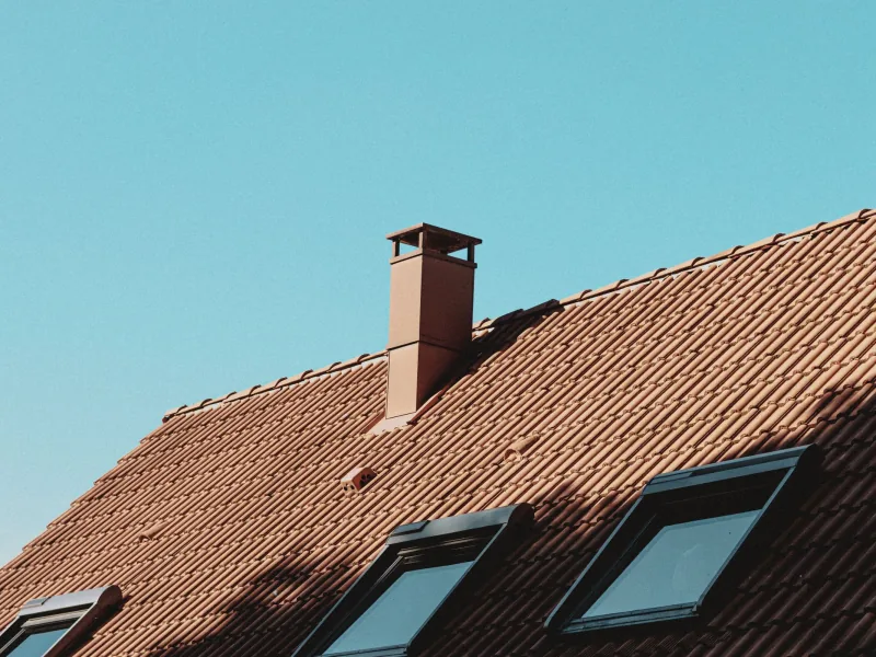 Terracotta clay tile roof with chimney