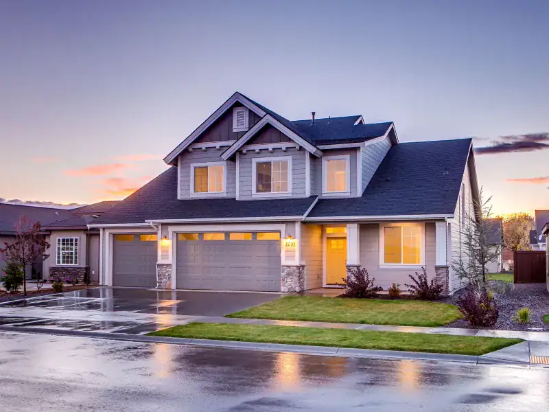 Garland home at dusk after a storm restoration roof replacement